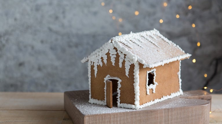 Built gingerbread house decorated in white icing